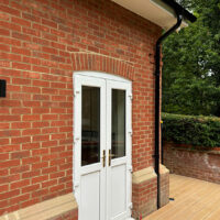 Black Lindab steel guttering and downpipes