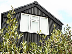 Composite black slatted cladding at rear of property in Surrey