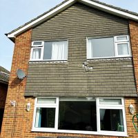 Damaged hanging tiles before installation of new cladding