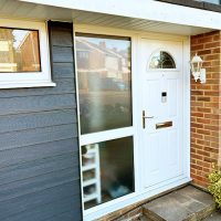 Newly installed grey cladding by front door