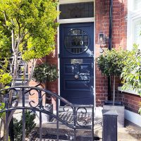 Blue front door with bespoke door canopy above