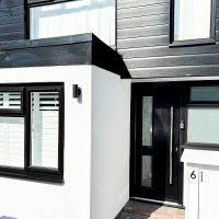 Black cladding installation around front door in Loughton, Essex