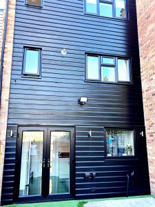 Re-installed black PVC cladding at rear