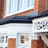 Door canopy detailing with fleur-de-lis design around the edge